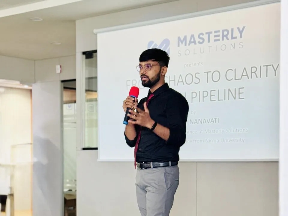 Harsh Nanavati on stage in front of the From Chaos to Clarity title slide